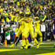Oregon Ducks linebacker Noah Sewell and Bennett Williams celebrate an interception against the Washington Huskies.